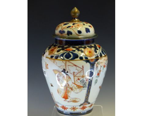 AN 18th C. JAPANESE IMARI JAR AND COVER, THE SHOULDERS AND LID WITH CHRYSANTHEMUMS IN LIGHT RELIEF, THE OVOID BODY WITH TWO R