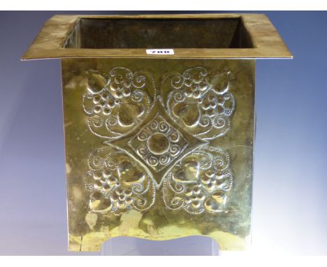 AN ARTS AND CRAFTS BRASS PLANTER, THE FLAT RIM OVER BOSSES ON TWO OF THE SQUARE SIDES AND A FLOWER HEAD QUATREFOIL ON ANOTHER