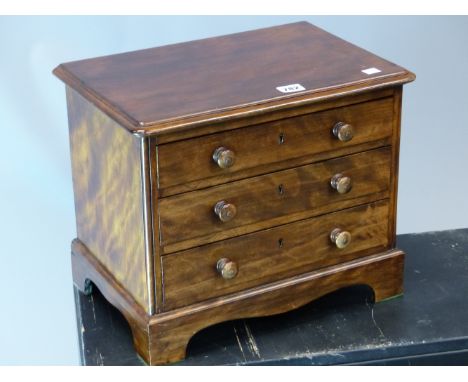 A 20th  C. MAHOGANY MINIATURE CHEST OF THREE DRAWERS ON BRACKET FEET.   W 41 x D 28 x H 33cms.