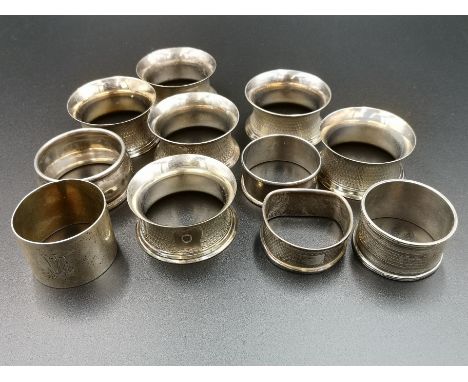 Four silver napkin rings, 57g; a silver napkin ring marked 800, 27g; six engine turned silver plate napkin rings. Estimate: £