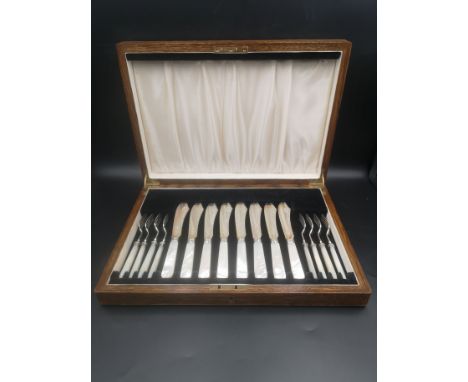 A canteen of fish knives and forks with silver blades and tines, with mother of pearl handles, Sheffield 1938. Estimate: £80-