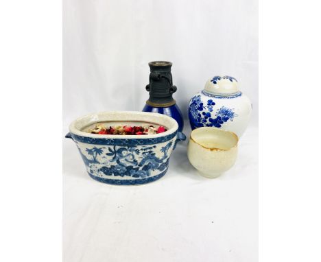 A blue and white ginger jar; a blue glazed vase; a blue and white planter together with another item of pottery. Estimate: £1