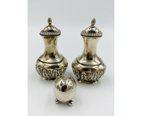 Pair of pepper pots, Chester 1902, 76gms, and a small three footed silver pepper pot, 14.5gms. Estimate £40-60