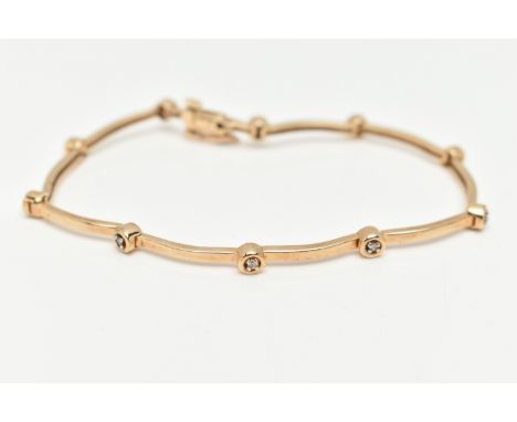 A 9CT YELLOW GOLD DIAMOND BRACELET, designed as a series of ten round brilliant cut diamonds, interspaced by plain polished l