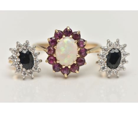 A 9CT GOLD GEM SET RING AND A PAIR OF EAR STUDS, the ring designed as a central opal within a circular cut ruby surround, rin