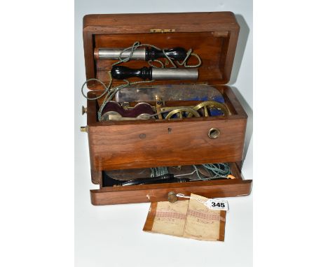 A HAND OPERATED ELECTROTHERAPY MACHINE, in a wooden case, with accessories and 'Brief Directions for Administering Electricit