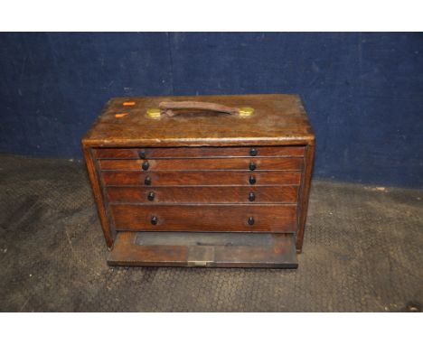 A VINTAGE WOODEN ENGINEERS TOOLCHEST with lock to front (no key), concealing five graduated drawers and a distressed leather 