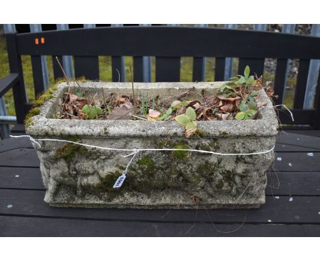 A WEATHERED COMPOSITE RECTANGULAR PLANTER, depicting putto to the sides, length 54cm (condition report: no cracks)
