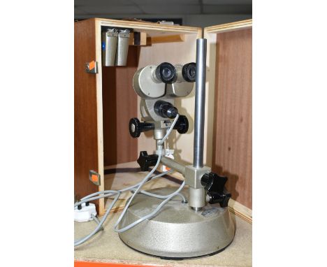 A CASED PRIOR ELECTRIC BINOCULAR MICROSCOPE, the case containing two additional lenses, not tested (Condition Report: the rub