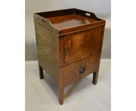 An Early 19th Century Mahogany Nightstand, the galleried top above a door and a pull-out commode raised upon square tapering 