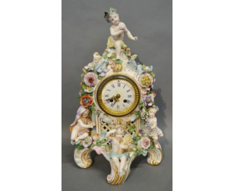 A 19th Century German Porcelain Table Clock with Putti Surmount amongst Foliage, the enamel dial with two train movement and 