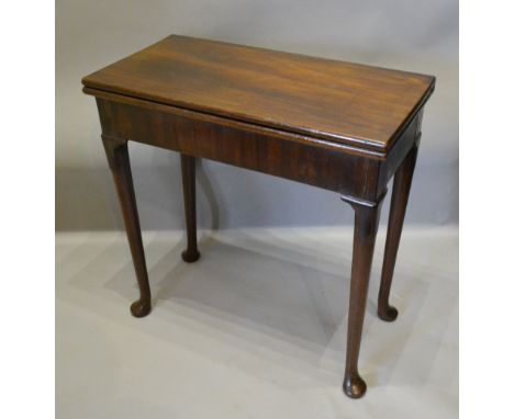 A George III Mahogany Rectangular Card Table of Rectangular Form, the hinged top above concertina legs above a plain frieze r