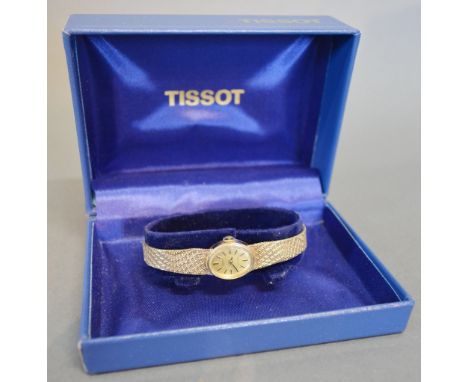 A Tissot 9ct. Gold Cased Ladies Wrist Watch together with a 9ct. Gold Strap