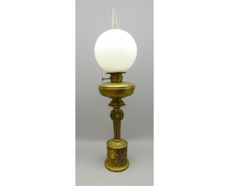 19th century gilt metal oil lamp base, decorated in high relief with scroll work and tapered column stem, H50cm    Condition 