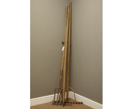 Two vintage wooden handled garden racks and two other vintage garden tools   Condition Report   Click here for further images