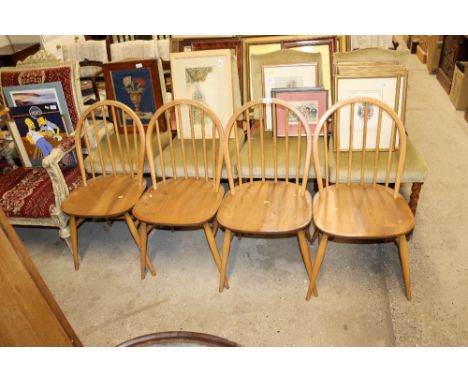 A set of four light Ercol stick back kitchen chairs 