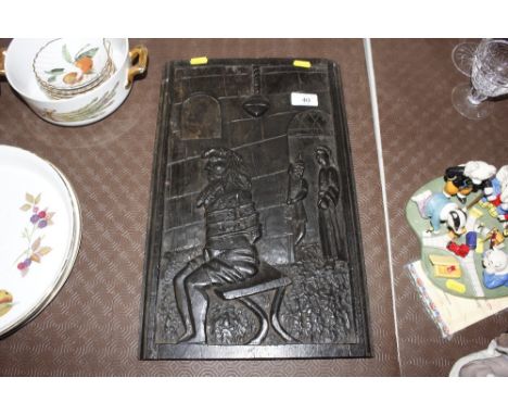 A carved wooden panel depicting a prisoner 