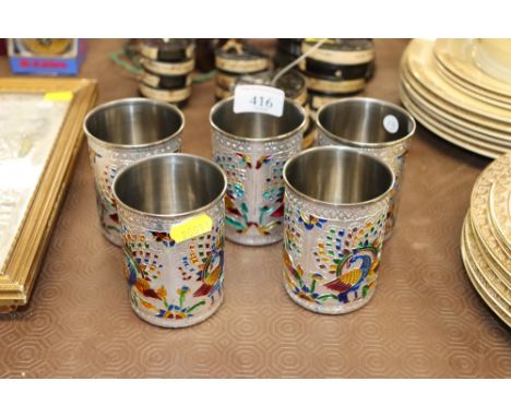 A set of five Indian white metal and enamel beakers decorated peacocks and foliage  