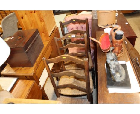 A set of three oak ladder back and rush seated dining chairs 