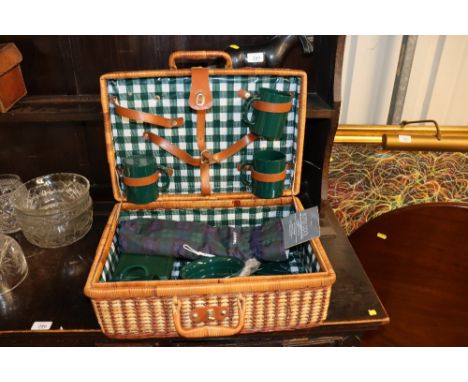 A wicker picnic hamper and contents 