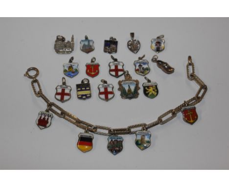 A silver charm bracelet and several silver and enamel charms 