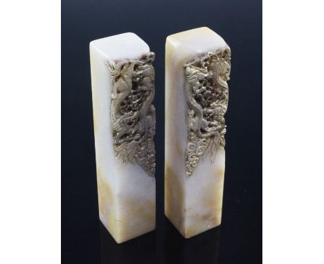 Two Chinese soapstone 'dragon' seals, early 20th century, carved in high relief to one side with two confronting dragons chas