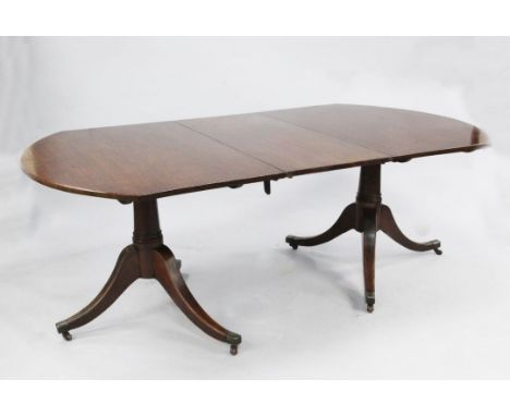 A Regency mahogany D end dining table with leaf, on ring turned columns and downswept legs.