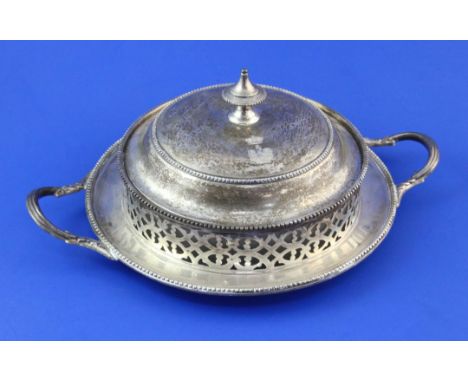 A Victorian pierced silver circular two-handled butter dish and cover, with glass liner and beaded borders, Henry Wilkinson &