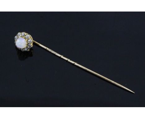 An early 20th century gold, white opal and diamond cluster stick pin, 2.25in.