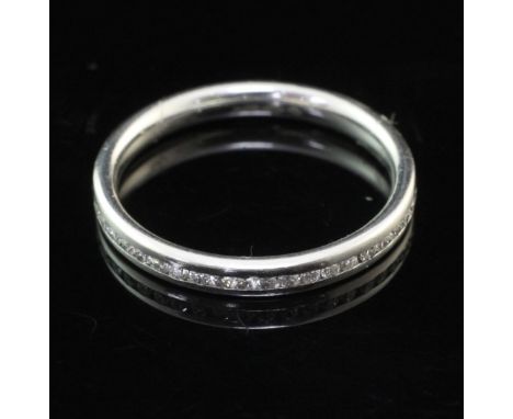 A modern platinum and diamond set full eternity ring, size M.