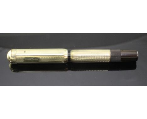 A gold plated Montblanc vintage safety pen with engine turned decoration, 4in.