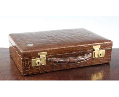 A small 1930's rectangular crocodile skin attache case, the front with circular monogram for JT, 14in.