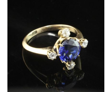 A gold, sapphire and diamond ring, the central round cut blue sapphire of good colour and bordered by four old cut diamonds, 