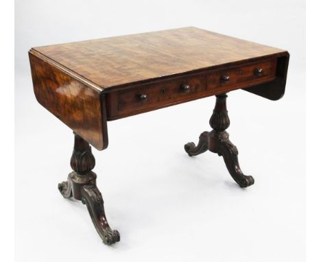 A Regency mahogany sofa table, with two frieze drawers opposing two dummy drawers, stiff leaf vase turned supports with downs