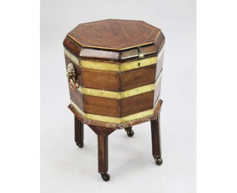 A George III and later octagonal brass bound mahogany cellaret, on square section supports and castor feet, mounted with lion