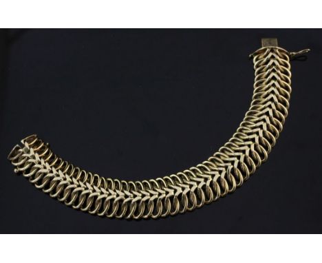 A stylish 1960's 9ct gold interwoven link bracelet, with central chevron motif, maker's, Smith & Pepper Ltd, 54.9 grams, 7.5i