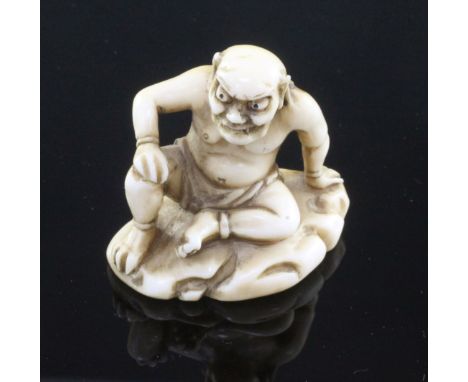 A Japanese ivory netsuke of Raiden (God of Thunder), signed Tomohiro, Edo period, seated on a rock, 4.3cm