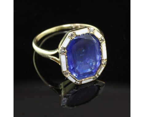 An attractive, gold, sapphire diamond and white enamel dress ring, of octagonal form, the central stone bordered by white ena