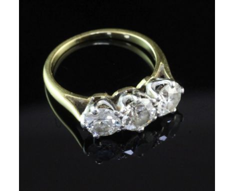 A gold and three stone diamond ring, the three round brilliant cut stones with a total diamond weight of approximately in exc