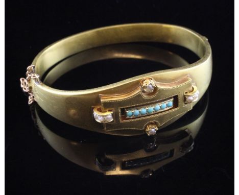 A late 19th/early 20th century Austro-Hungarian 14ct gold, turquoise and seed pearl set hinged bangle, with central shaped re