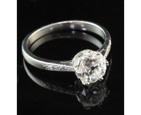 A platinum and single stone diamond ring with diamond set shoulders, the central old cut stone weighing approximately 1.00ct,