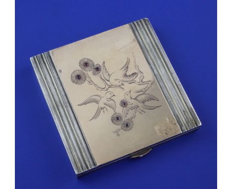 A 1930's/1940's French parcel gilt silver and gem set compact, of square form, the lid engraved with birds on a branch and se