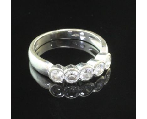 An 18ct white gold and five stone diamond half hoop ring, the collet set stones with an estimated total weight of 0.70ct-0.80