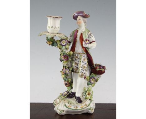 A Derby porcelain candlestick figure, late 18th century, modelled as a gentleman holding a posy of flowers and a basket of fr