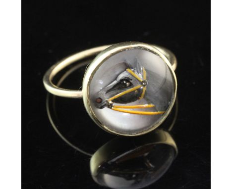 A gold and Essex crystal ring, of circular form, decorated with a horse's head, size M.