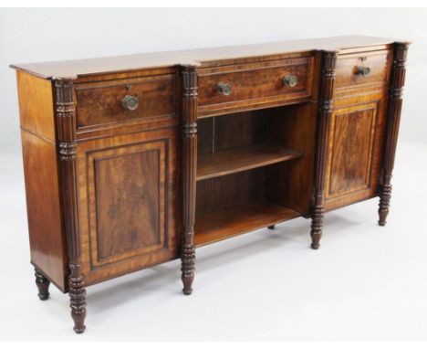 Attributed to Gillows of Lancaster. A Regency mahogany dwarf bookcase, with three frieze drawers over central open shelves fl