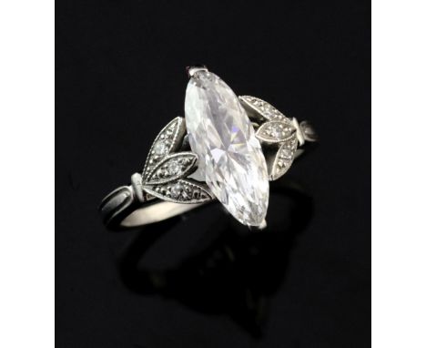 A good platinum and single stone marquise diamond ring, with diamond set foliate shoulders and accompanying Gem A grading rep