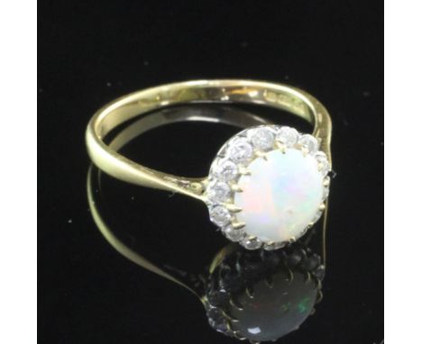 A late 1970's 18ct gold, white opal and diamond cluster ring, size T.