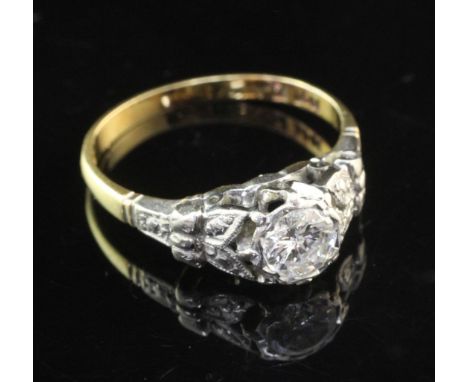 A 1940's/1950/s 18ct gold and platinum solitaire diamond ring, with engraved shoulders and collet set stone weighing approxim
