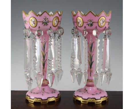 A pair of Victorian pink and white overlaid glass table lustres, with crenellated rims, decorated with classical portrait med